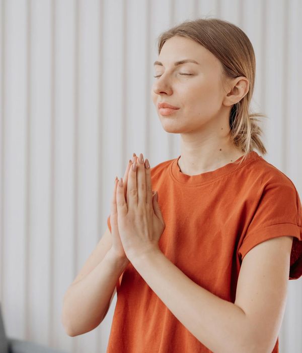 Woman meditating in a serene yoga pose with calming colors.